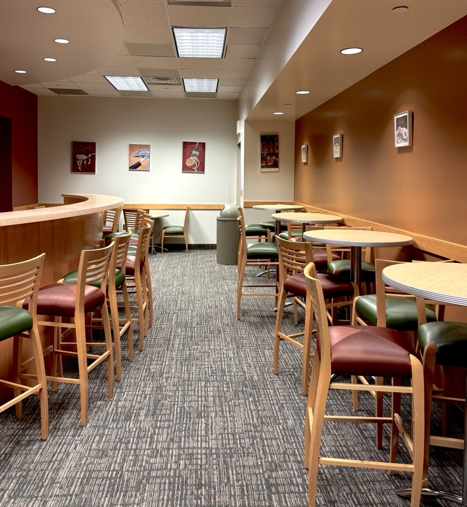 Reception area with chairs, tables, and bar seating